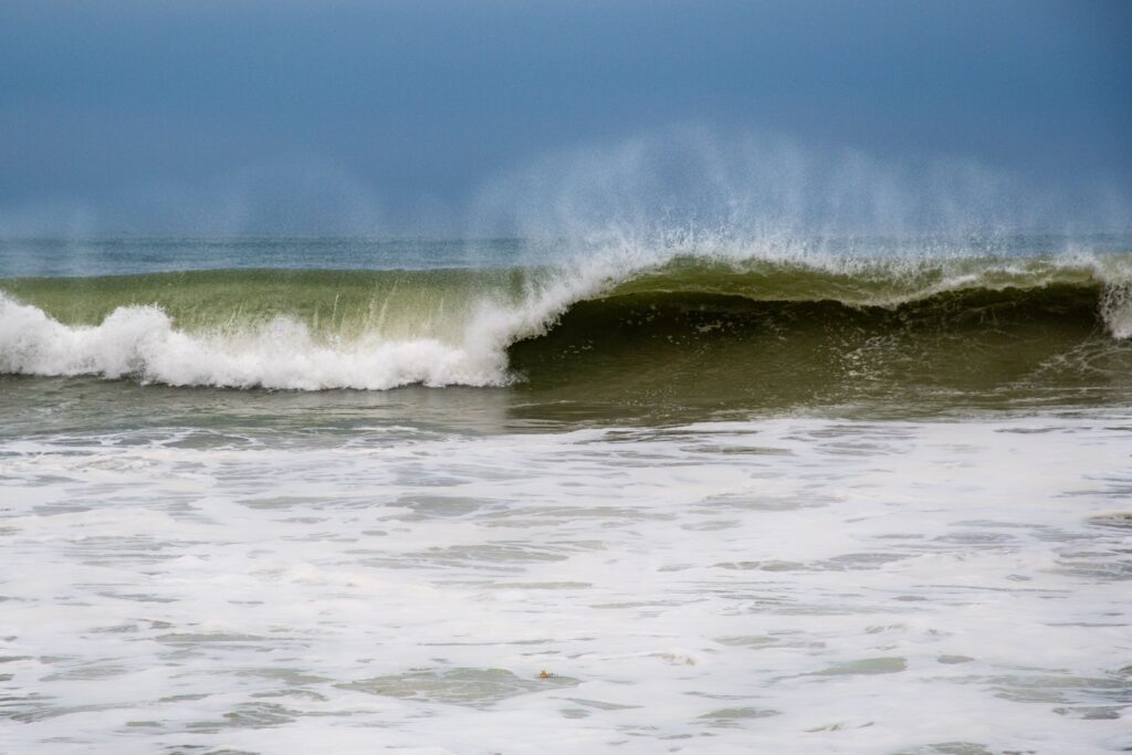 Vivid photograph of an ocean wave crashing, showcasing nature's power and beauty.